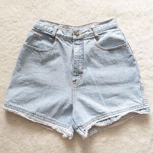 Vintage 90’s Manisha high waisted light wash blue denim shorts with a ruffle hem